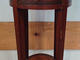 a small wooden table with a drawer on top of it