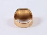 an image of a gold ring sitting on top of a white surface
