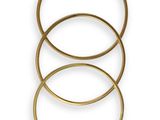 a set of three gold rings on a white background