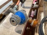 a close up of a blue valve on a wooden table