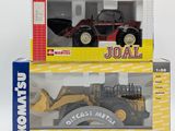 two boxes with a toy tractor and a toy bulldozer in them