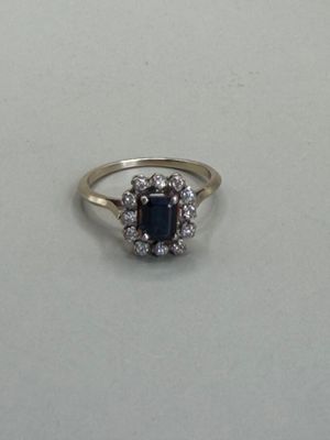 an image of a diamond and sapphire ring on a table