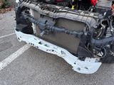 a picture of a car with a broken engine in a parking lot
