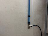 a blue hose attached to a wall next to a box