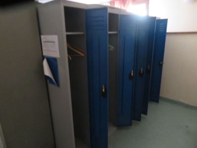 several blue lockers are lined up in a row in a room