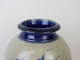 a blue and white vase sitting on a table