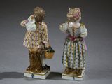 two figurines of two women with baskets on their heads