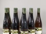 six bottles of wine are lined up in a row