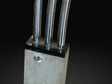 a knife block with three knives sticking out of it
