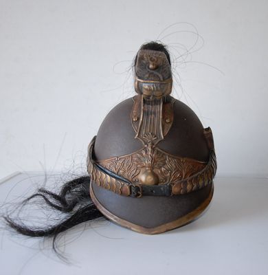 a helmet with a long black hair on a table