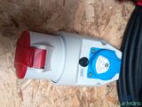 a red and white water pump sitting on a wooden floor