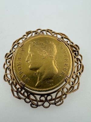 a close up of a gold coin in a broocher