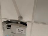 a small electronic device attached to the ceiling of a bathroom