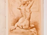 an old book with a drawing of a nude woman sitting on a bed