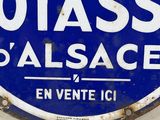 a blue and white sign on the side of a building