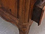 a wooden cabinet with a drawer on top of it