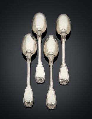 three silver spoons and a spoon rest on a black surface