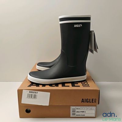 an image of a pair of black rain boots sitting on top of a box