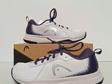 a pair of tennis shoes in a box on a table