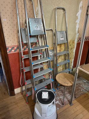 a ladder that is leaning against a wall in a room