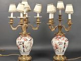 pair of antique chinese vases with lamps on stands on a gray surface