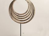 a close up of a metal object with rings on a stand
