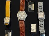 a lot of watches that are laying out on the table