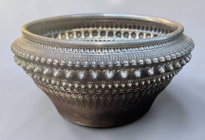 a silver bowl that is sitting on a table