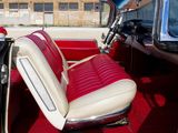 a red and white interior of a classic car