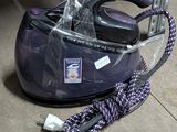 a vacuum that is sitting on the floor next to a bag
