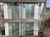 a stack of windows that are wrapped up and sitting on a pallet