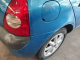 a small blue car parked in a garage