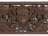 a close up of a decorative wooden panel on a white background