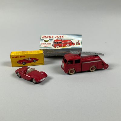 un petit camion rouge et une petite voiture rouge, l'un à côté de l'autre