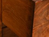a close up of a drawer in a wooden cabinet
