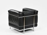 the back of a black leather chair on a white background