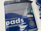 a bag of microfibre pads on a table next to a toothbrush and toothpaste