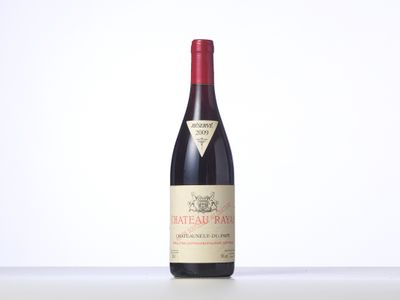 a bottle of red wine sitting on top of a table