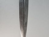 a large knife hanging on the wall in the room