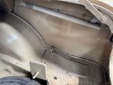 a dirty car with the door open and the front seat down