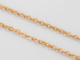 a pair of gold chains on a white background