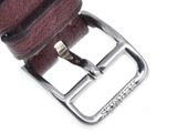leather belt with a metal buckle on a white background