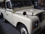 a white land rover parked in a garage next to other cars