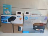 many boxes on the shelf of a store with a printer on it