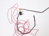 a red wire that has been tangled up on the ground