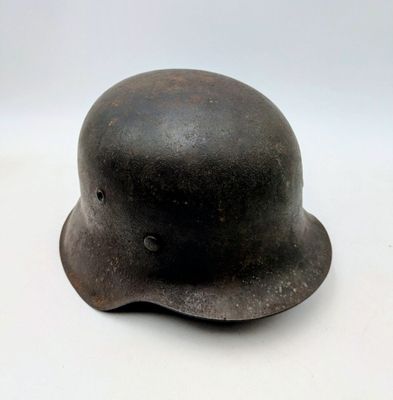 an old helmet is sitting on a white surface with a white background