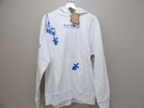 white hoodie with blue flowers on it hanging on a hanger