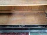 a wooden shelf with a drawer on top of it