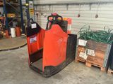 a forklift with a red container on it in a warehouse