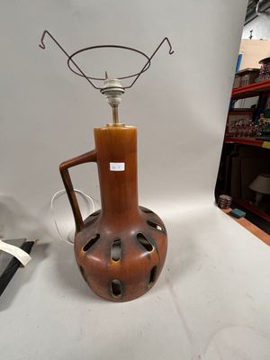 a brown vase that has a light on top of it